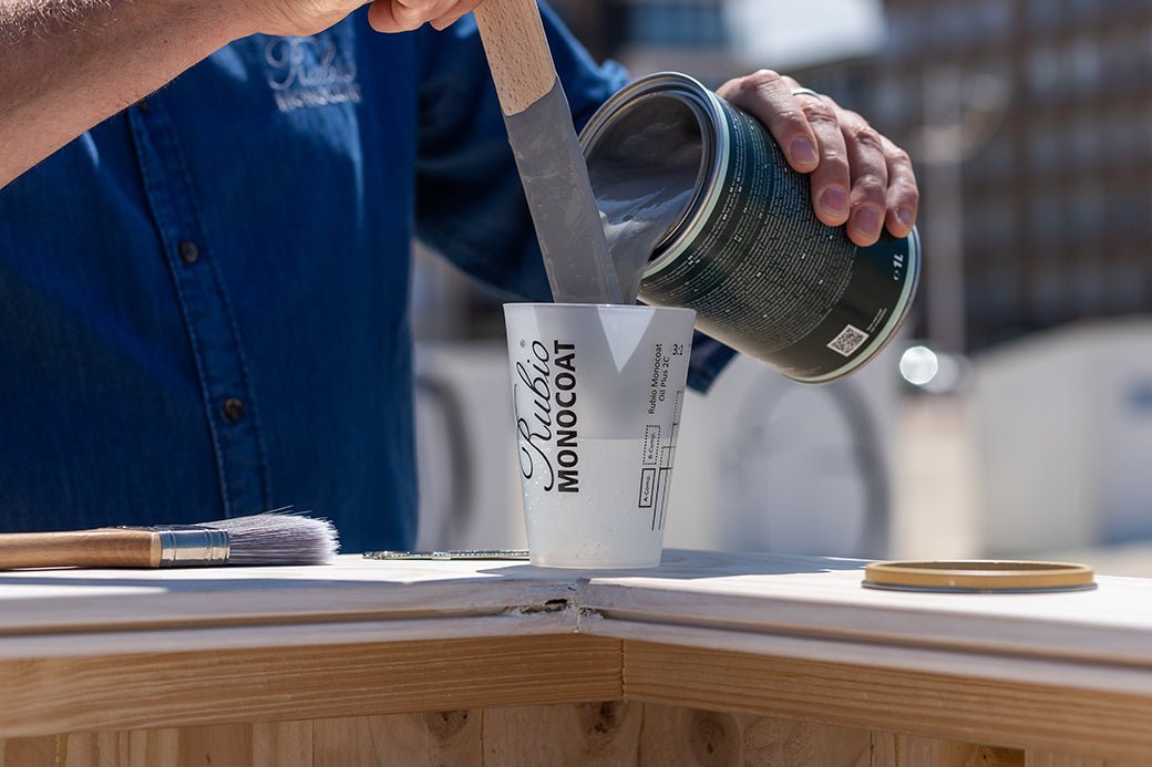 Person pouring Rubio Monocoat WoodCream into a measuring cup.